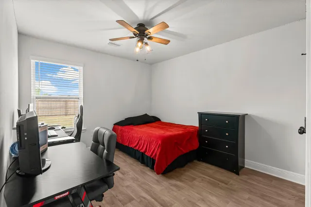 a bedroom with a bed and a chandelier