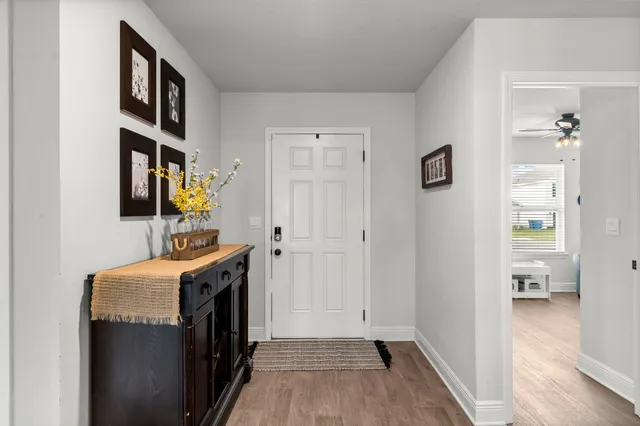 a view of hallway with wooden floor