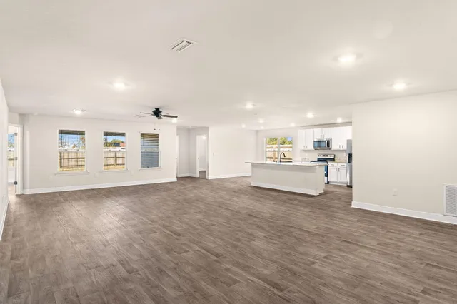 a view of hallway with wooden floor