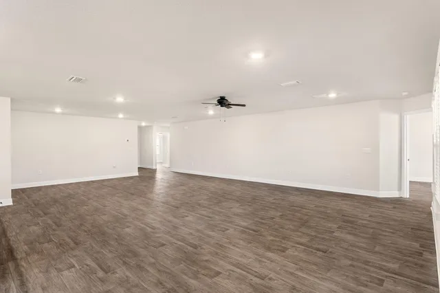 a view of a livingroom with furniture cabinets and wooden floor