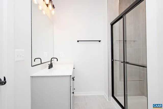a bathroom with a glass shower door
