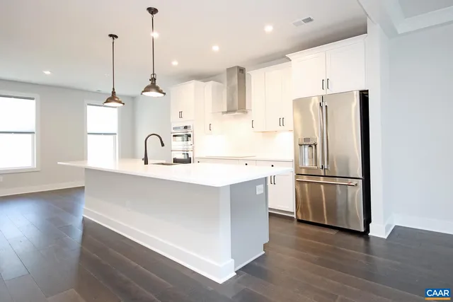 a kitchen with stainless steel appliances a refrigerator and a sink