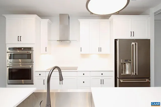 a kitchen with granite countertop a refrigerator and a stove