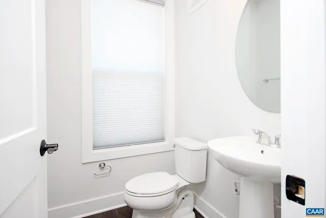 a white toilet sitting next to a bathroom sink