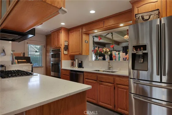 a kitchen with stainless steel appliances granite countertop a refrigerator and a sink