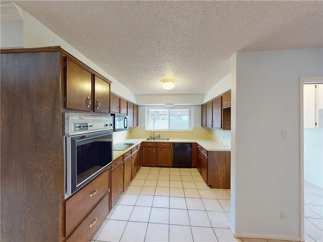 a kitchen with stainless steel appliances granite countertop a stove and a refrigerator