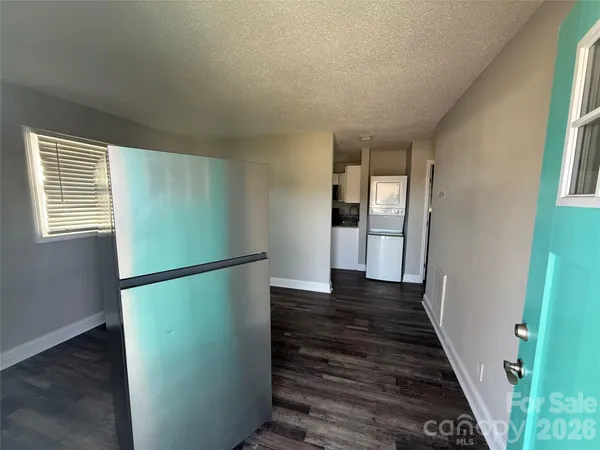 a kitchen with granite countertop a sink stove and refrigerator