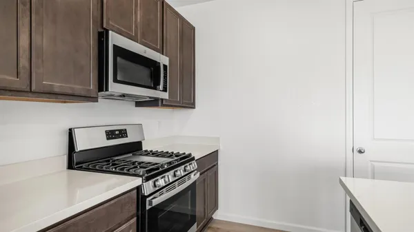 a kitchen with a stove and a microwave