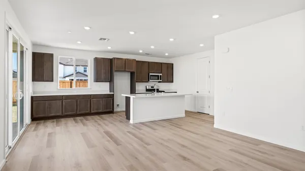 a large kitchen with stainless steel appliances sink a microwave and cabinets