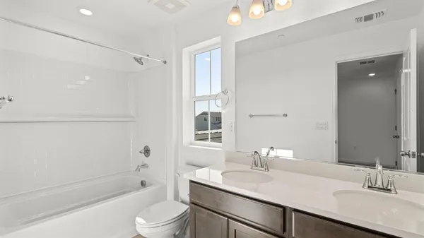 a bathroom with a granite countertop sink toilet a mirror and shower