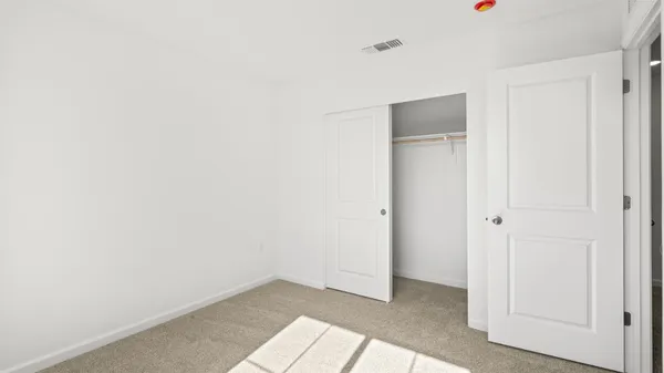 a view of an empty room and a window