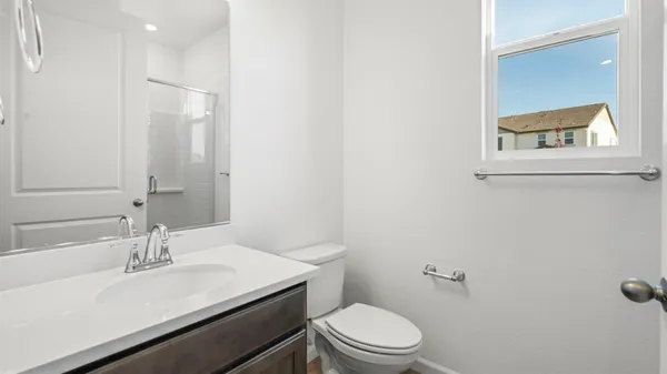 a bathroom with a sink a toilet and a mirror