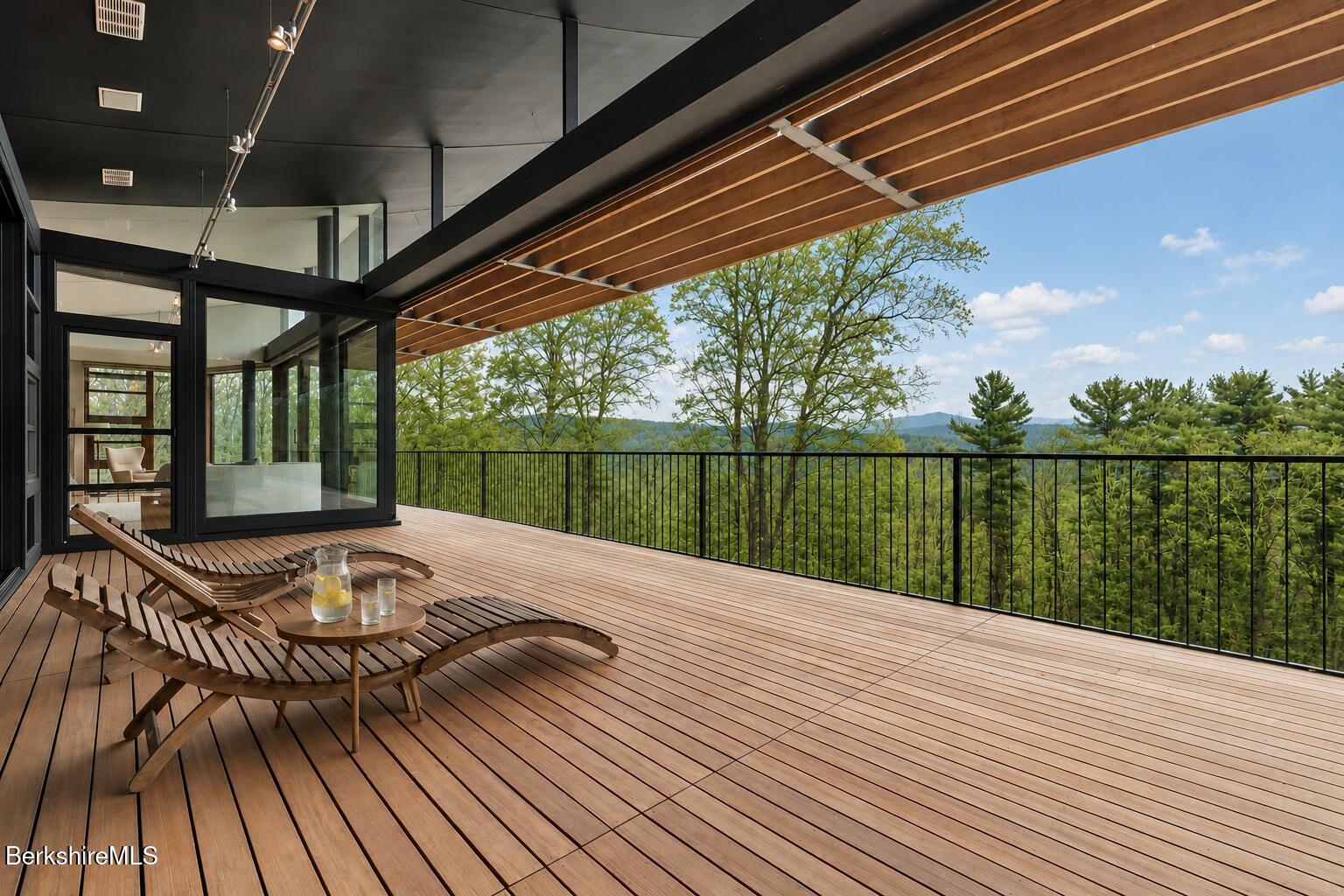 250 Long Pond Road Great Barrington, MA 01230 - Photo 23 of 56 a roof deck with table and chairs and wooden floor