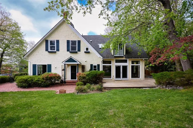 a front view of a house with a garden and plants