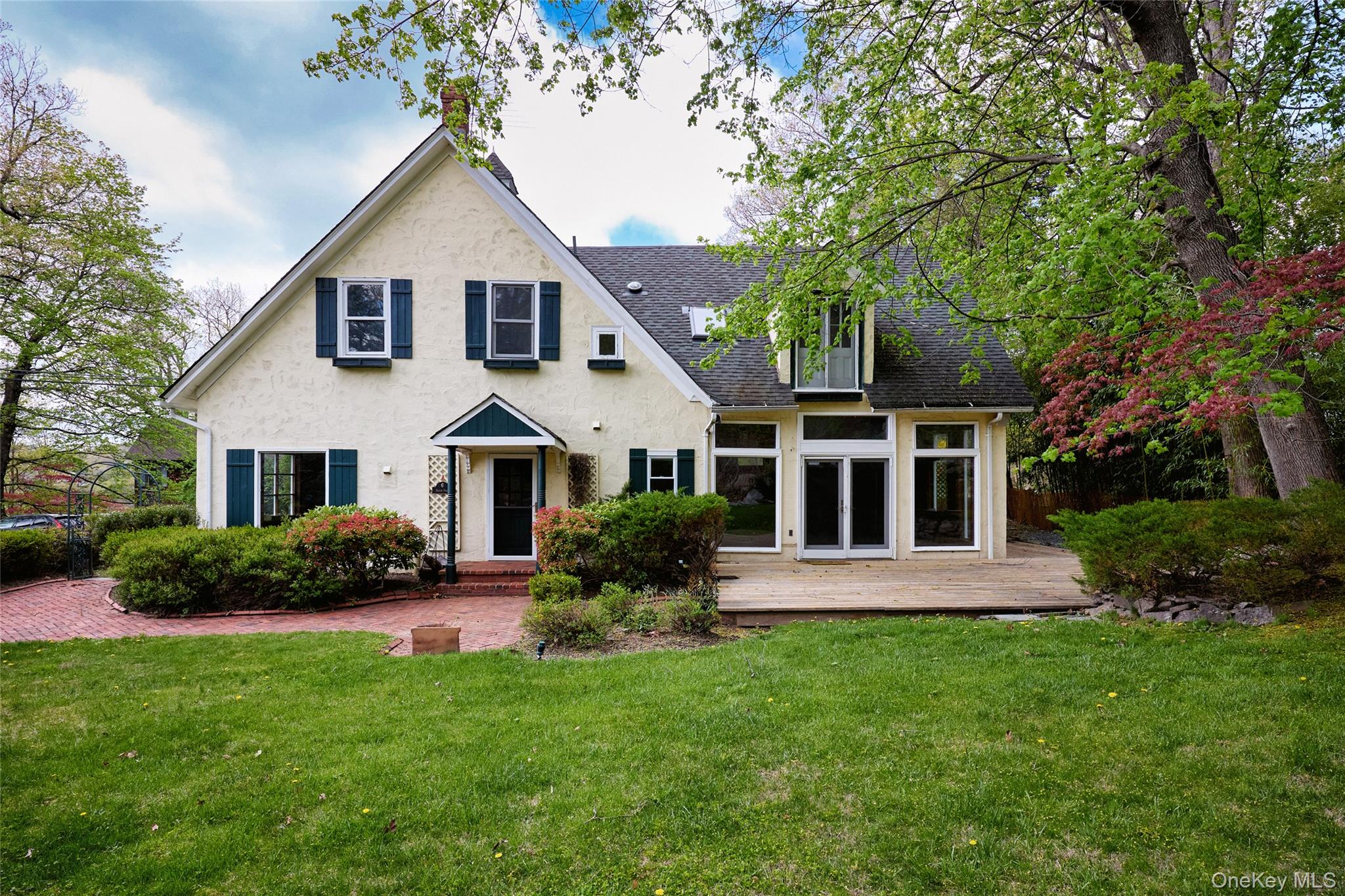 6 Stable Road Tuxedo Park, NY 10987 - Photo 1 of 28 a front view of a house with a garden and plants