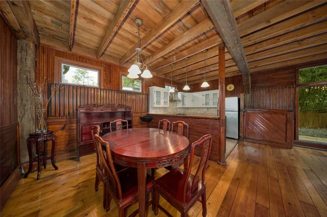 a view of a room with wooden floor and a window