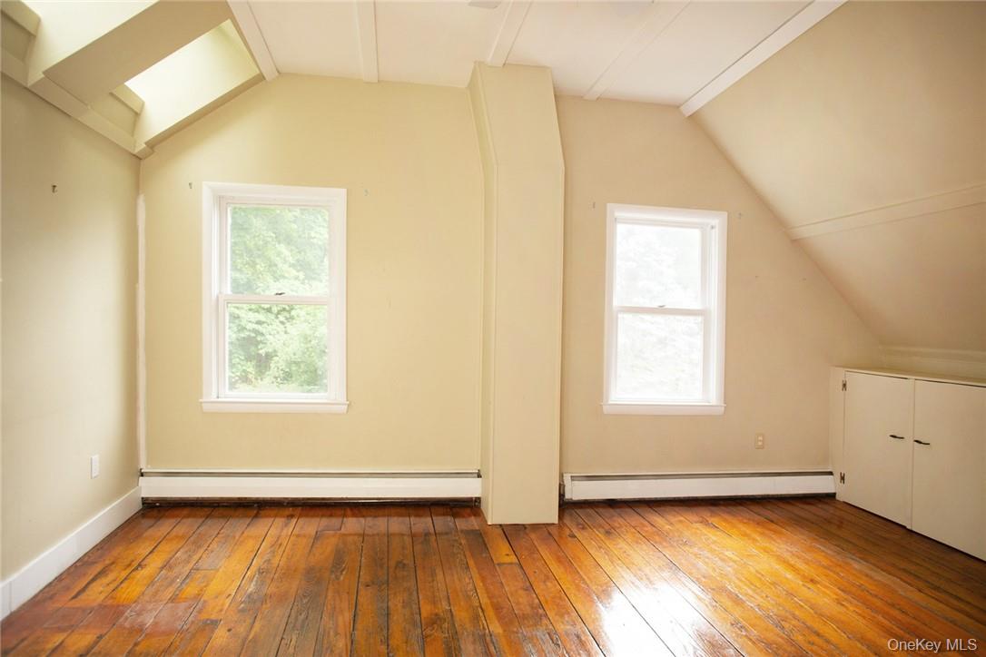 6 Stable Road Tuxedo Park, NY 10987 - Photo 18 of 28 an empty room with wooden floor and windows
