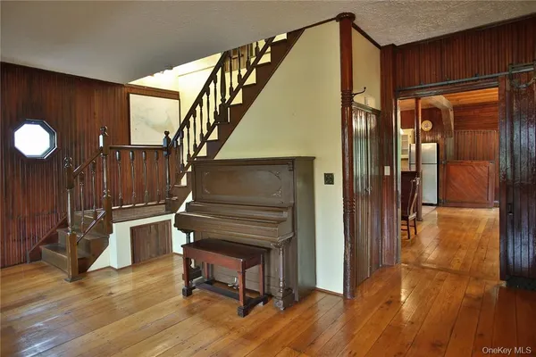 a view of entryway and hall with wooden floor