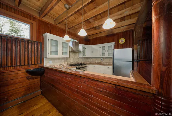 a kitchen with stainless steel appliances granite countertop a refrigerator and a stove