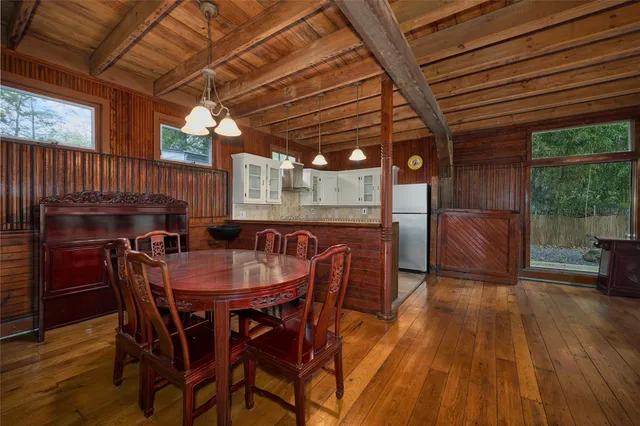 a dining room with furniture and wooden floor