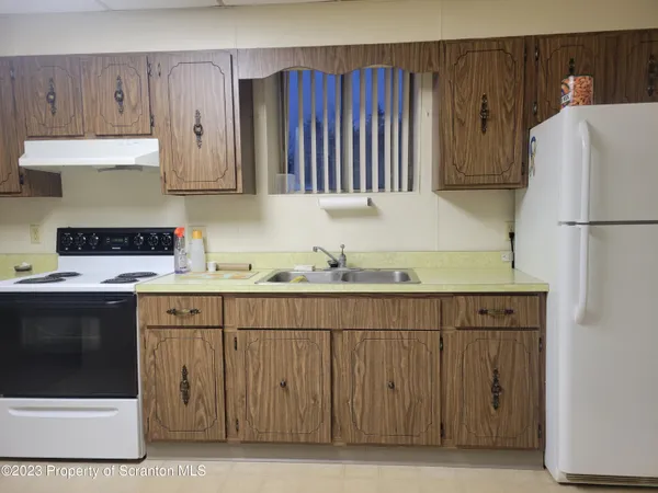 a kitchen with a sink and a refrigerator