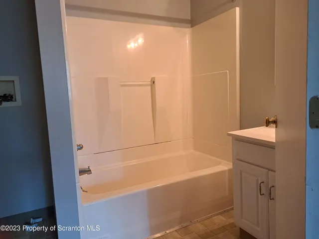 a bathroom with a bathtub and a sink