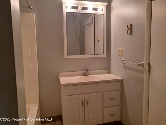 a bathroom with a sink and mirror