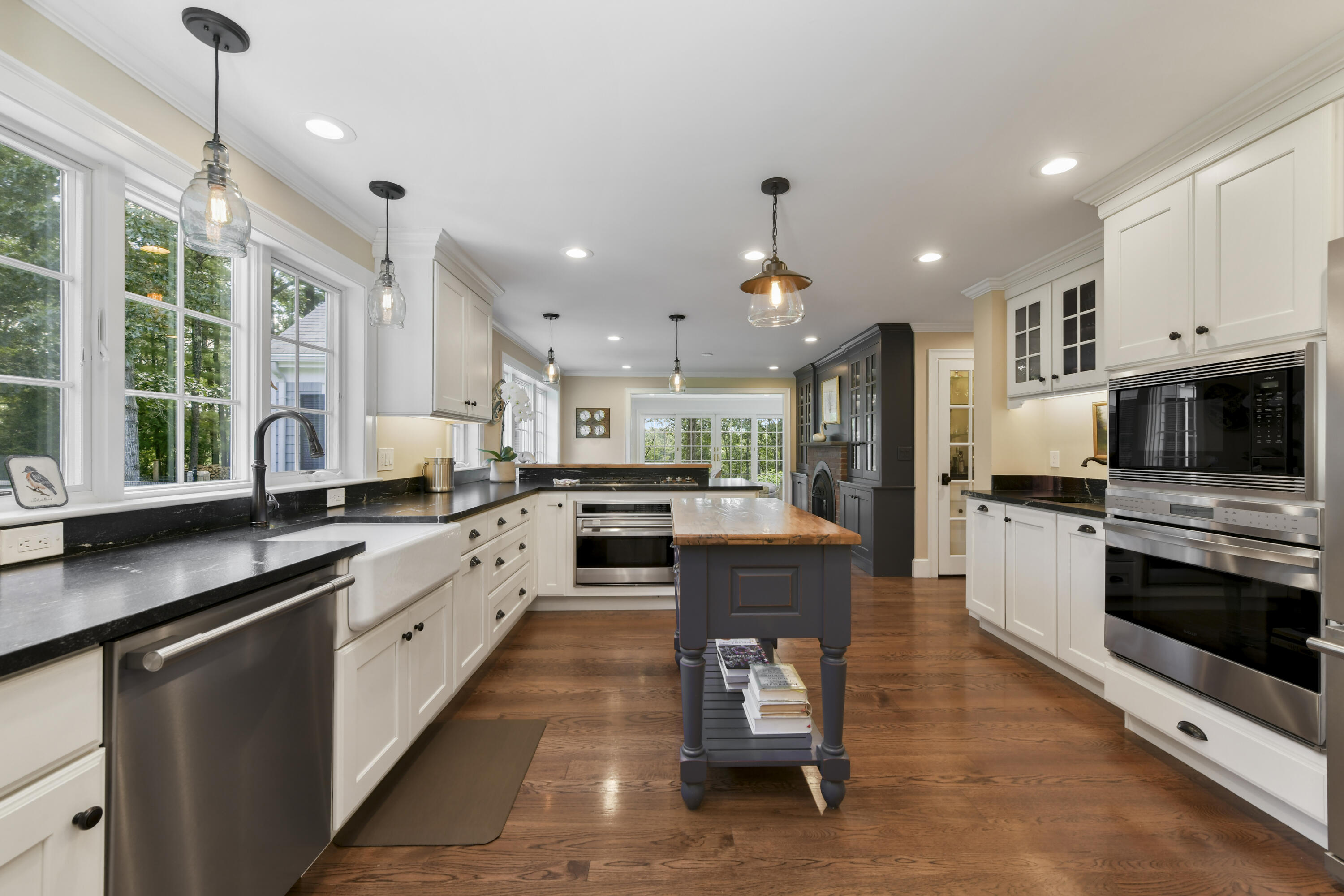 175 Starboard Lane Osterville, MA 02655 - Photo 18 of 39 a kitchen with stainless steel appliances kitchen island granite countertop a stove top oven a sink a dining table and chairs
