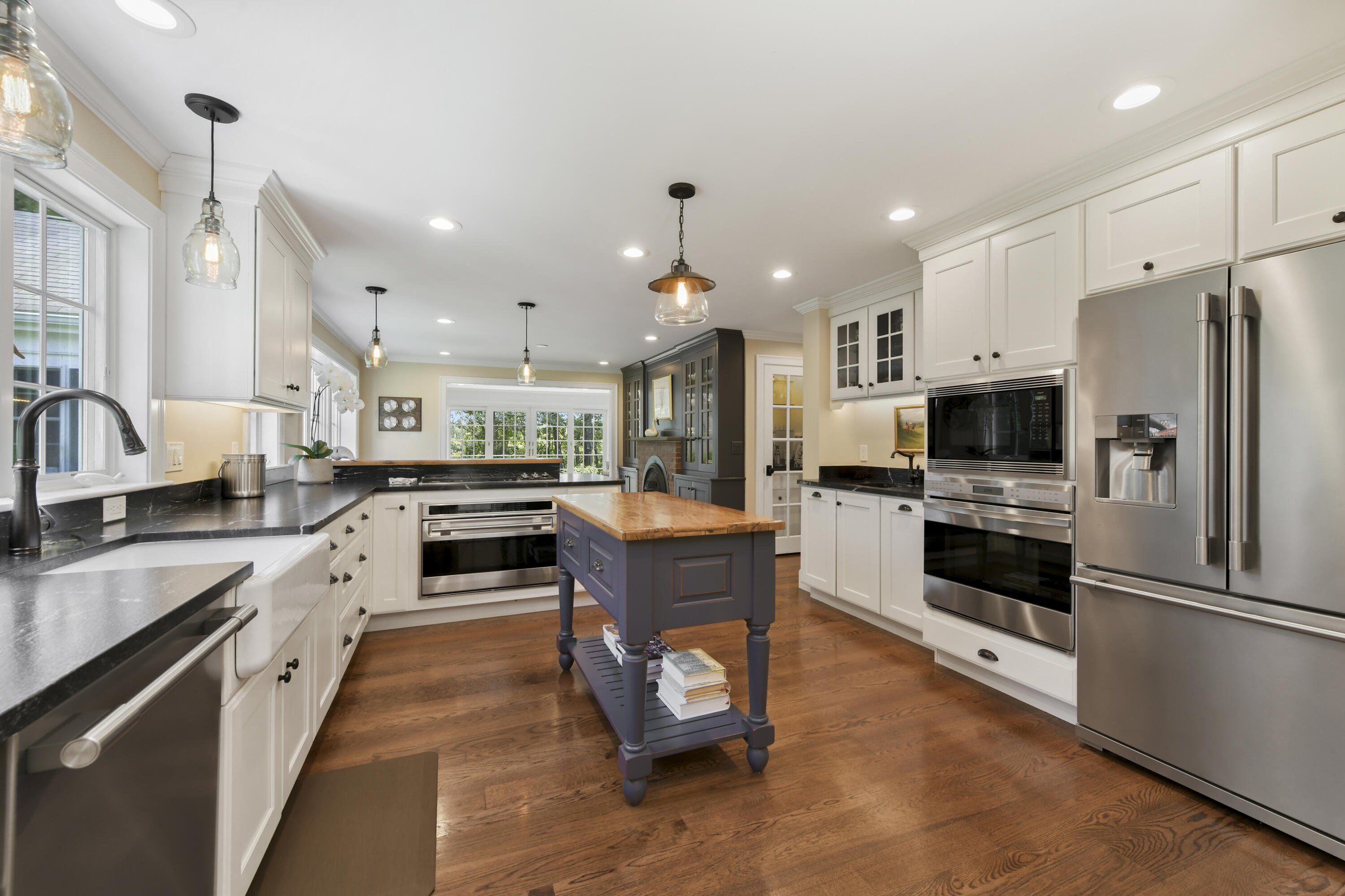 175 Starboard Lane Osterville, MA 02655 - Photo 19 of 39 a large kitchen with stainless steel appliances kitchen island granite countertop a refrigerator a stove a sink dishwasher a oven with white cabinets and wooden floor