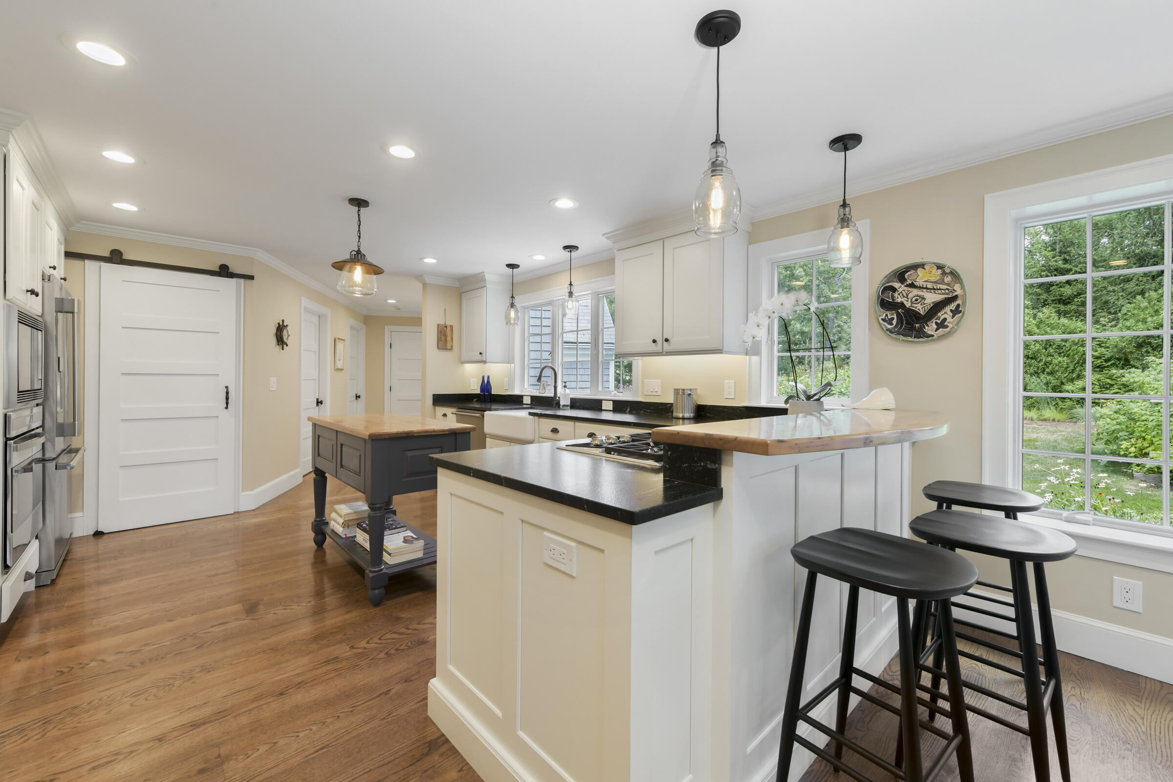 175 Starboard Lane Osterville, MA 02655 - Photo 20 of 39 a kitchen with a table chairs refrigerator and cabinets