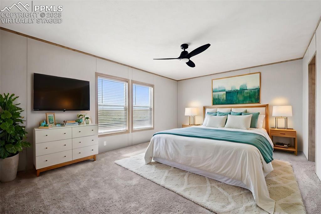 30495 Darroll Drive Yoder, CO 80864 - Photo 12 of 34 a bedroom with a bed flat screen tv and a window