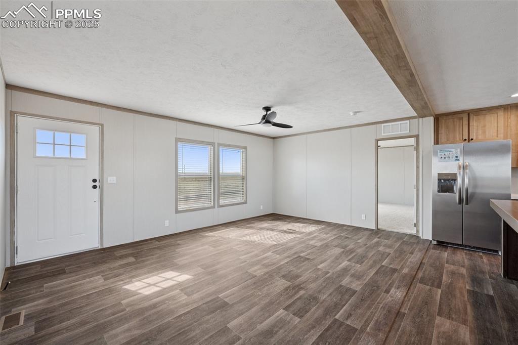 30495 Darroll Drive Yoder, CO 80864 - Photo 3 of 34 a view of empty room with wooden floor and window