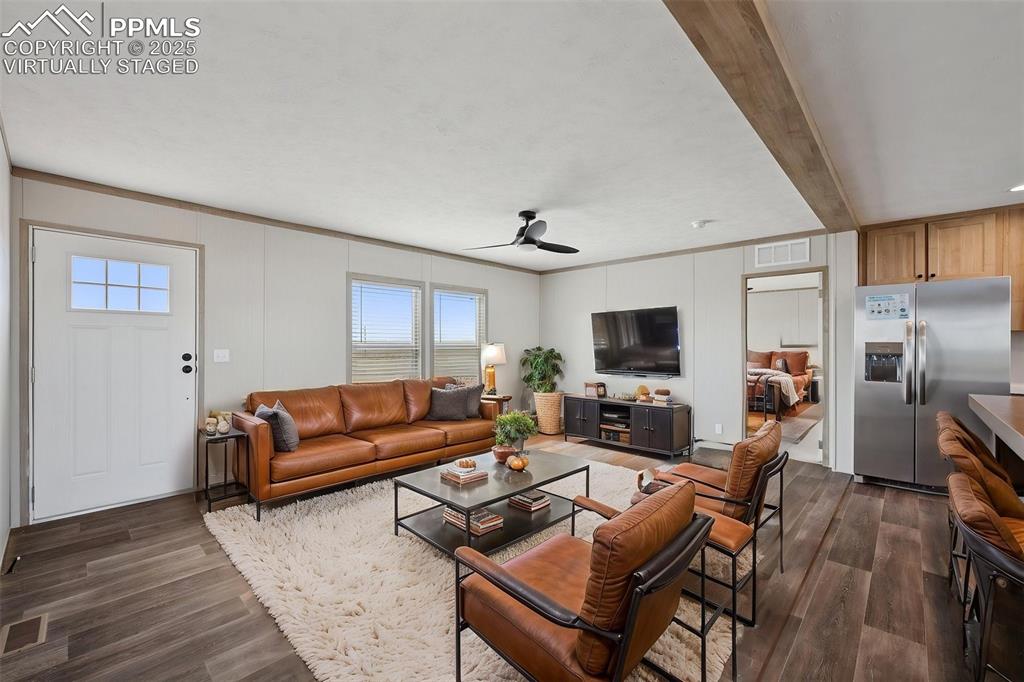 30495 Darroll Drive Yoder, CO 80864 - Photo 4 of 34 a living room with furniture a flat screen tv and a fireplace