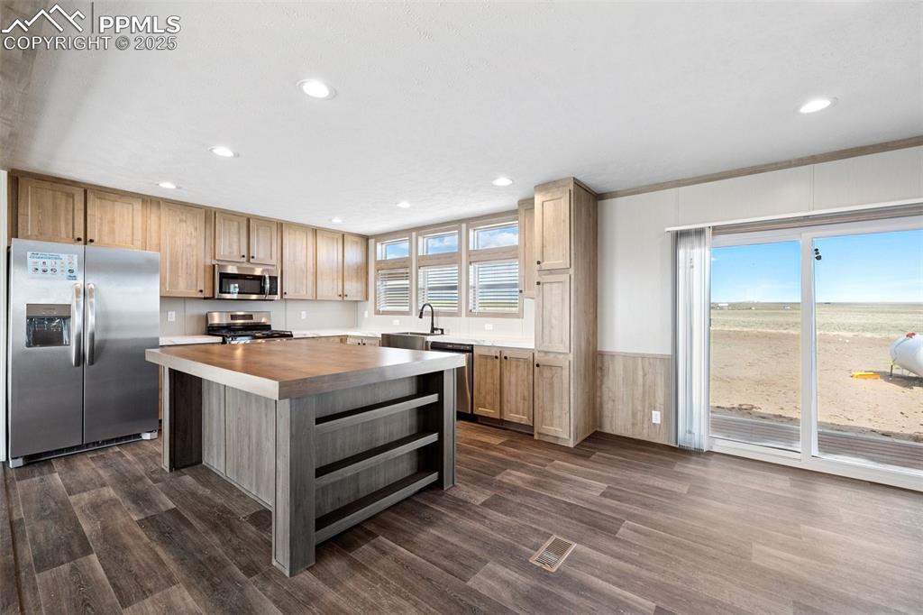 30495 Darroll Drive Yoder, CO 80864 - Photo 5 of 34 a kitchen with stainless steel appliances granite countertop a stove and a refrigerator