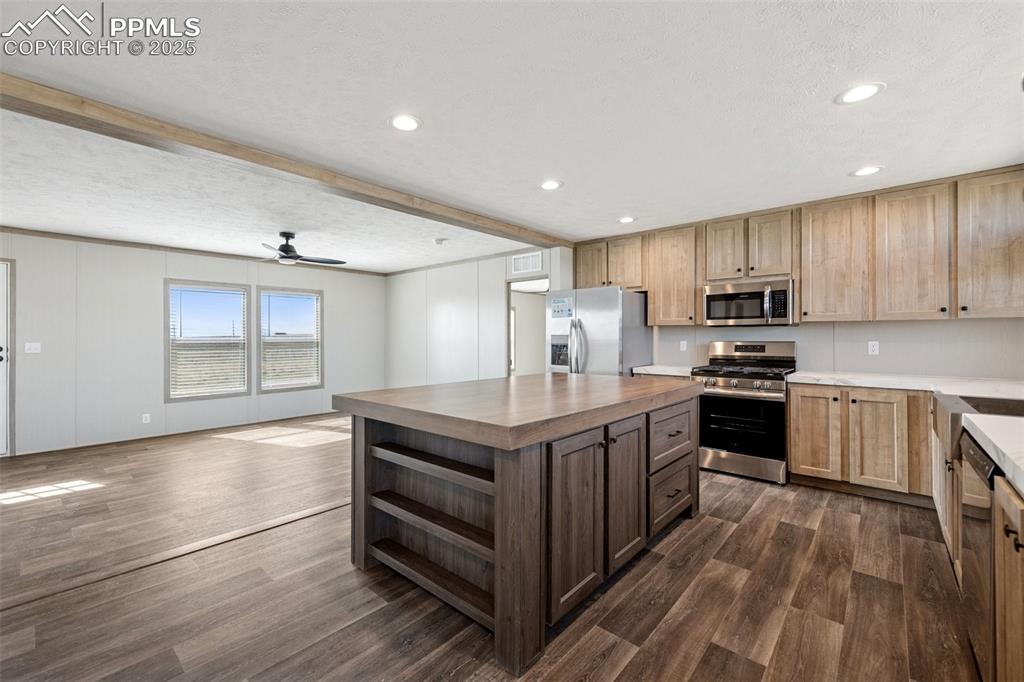 30495 Darroll Drive Yoder, CO 80864 - Photo 7 of 34 a kitchen with stainless steel appliances granite countertop a stove and a refrigerator