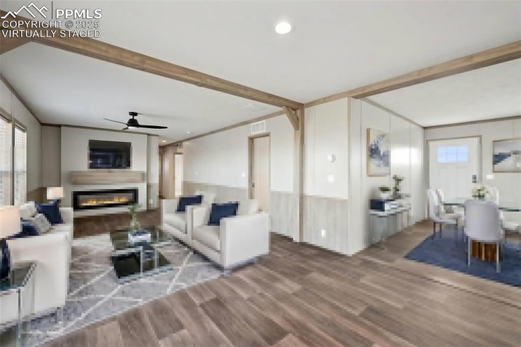 30495 Darroll Drive Yoder, CO 80864 - Photo 10 of 34 a living room with furniture a fireplace and a open kitchen view