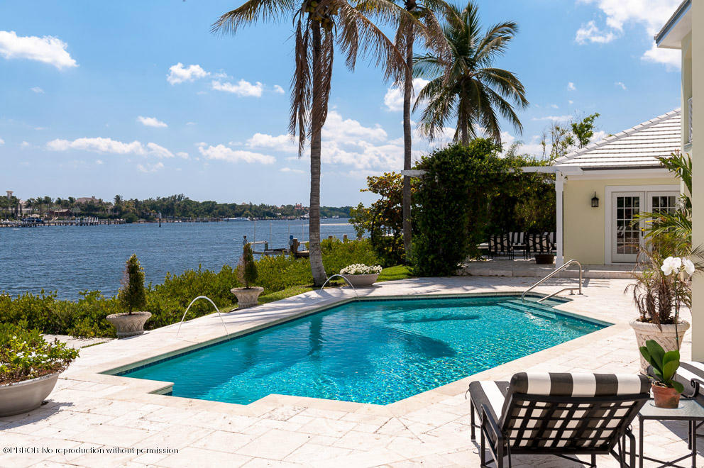 a view of a swimming pool with a lounge chairs