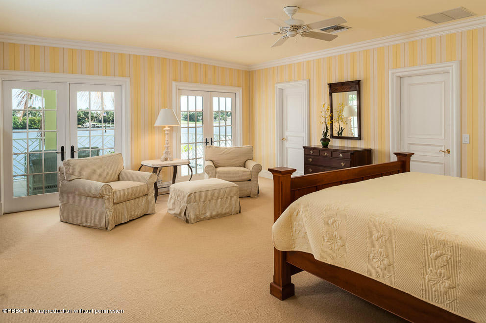 1630 Lands End Road Manalapan, FL 33462 - Photo 15 of 19 a spacious bedroom with a bed and glass window