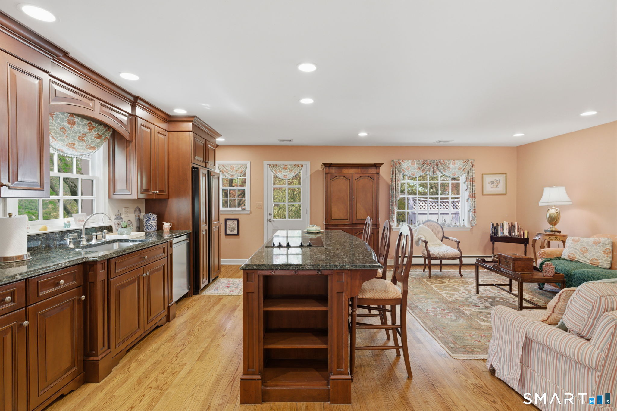 25 Norwood Road West Hartford, CT 06117 - Photo 13 of 40 a dining hall with stainless steel appliances granite countertop a stove top oven a dining table and chairs