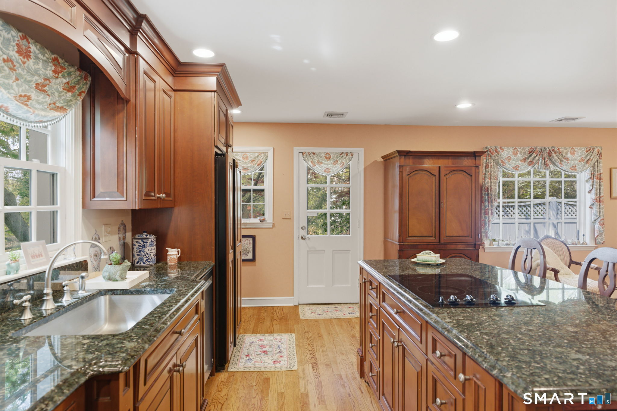 25 Norwood Road West Hartford, CT 06117 - Photo 19 of 40 a kitchen with granite countertop a sink stove and cabinets