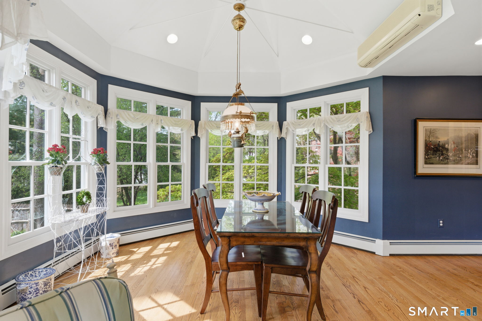 25 Norwood Road West Hartford, CT 06117 - Photo 22 of 40 a view of a dining room with furniture large windows and wooden floor