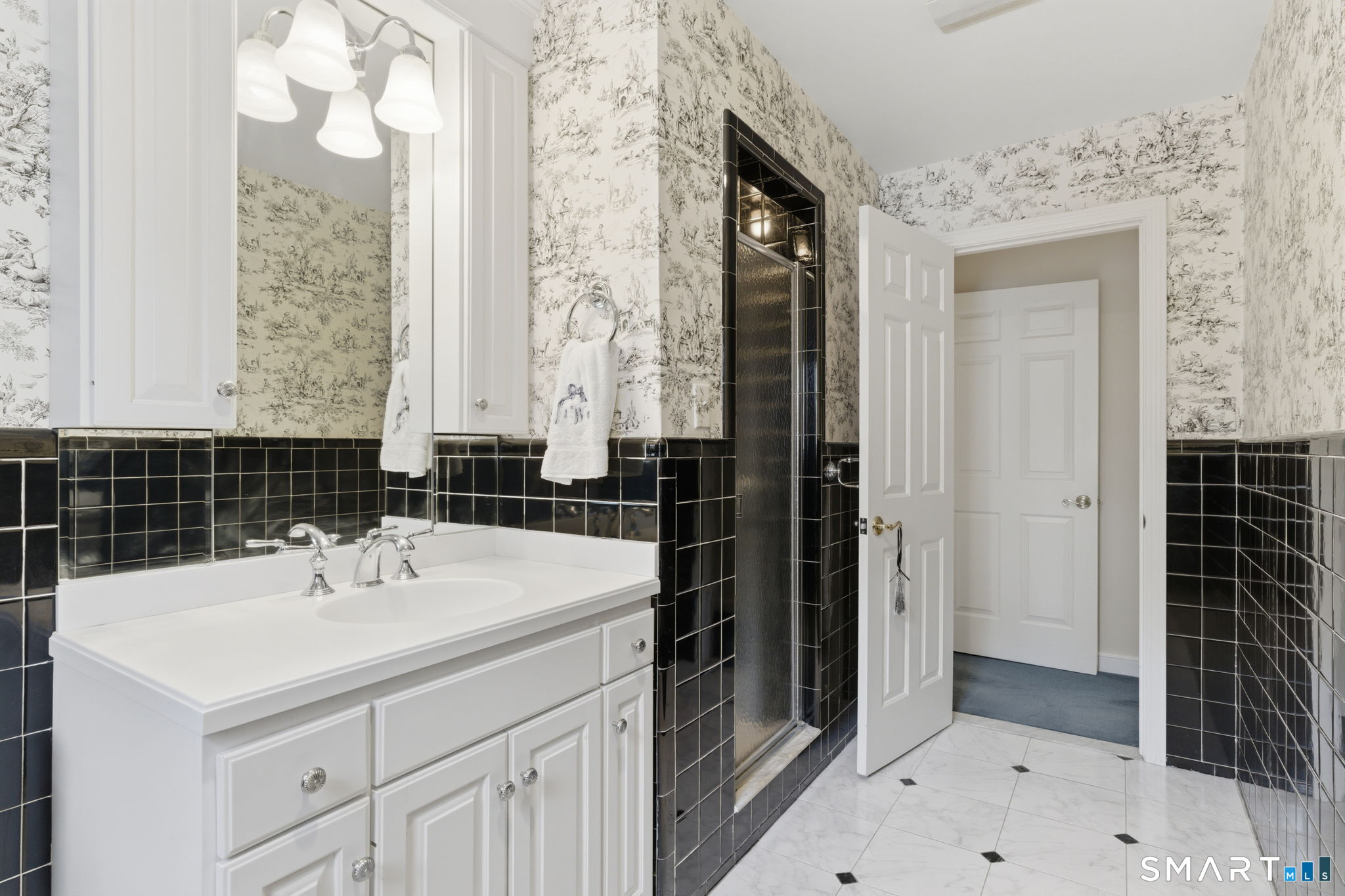 25 Norwood Road West Hartford, CT 06117 - Photo 27 of 40 a bathroom with a sink a mirror and a shower