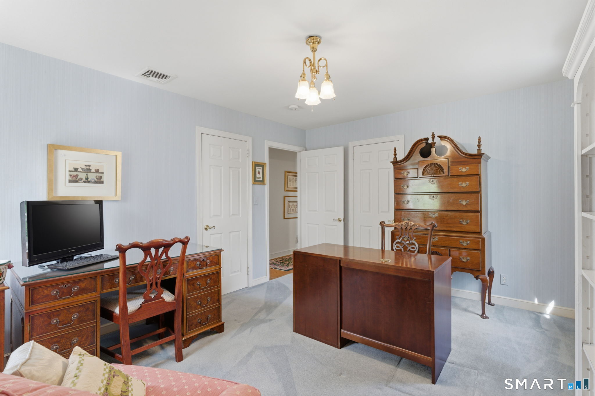 25 Norwood Road West Hartford, CT 06117 - Photo 29 of 40 a bedroom with furniture and a flat screen tv