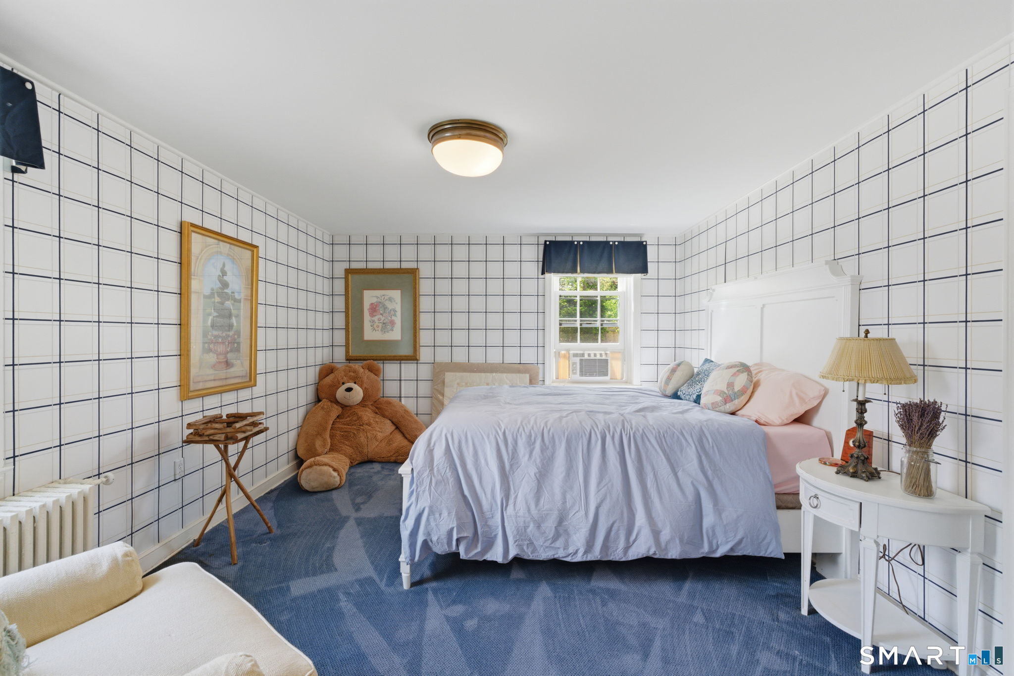 25 Norwood Road West Hartford, CT 06117 - Photo 35 of 40 a bedroom with a bed and wooden floor