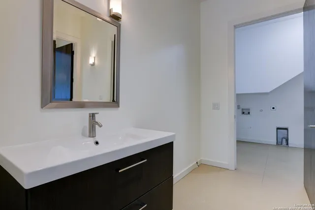 a bathroom with a sink and a mirror