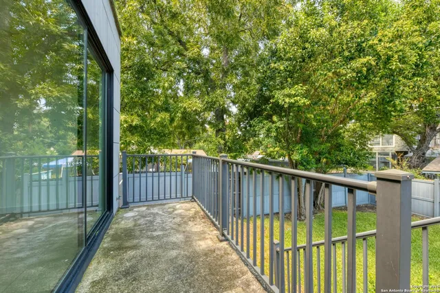 a view of a backyard with a small cabin and wooden fence