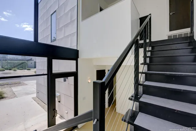 a view of a kitchen with stainless steel appliances a refrigerator and a sink