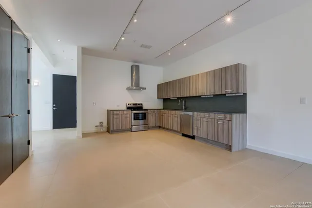 a kitchen with cabinets and a stove top oven