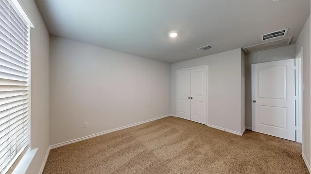 a view of an empty room and a window