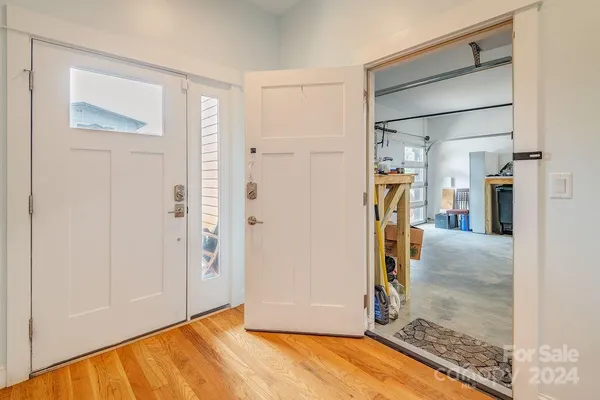 a view of a room with wooden floor and a bathroom